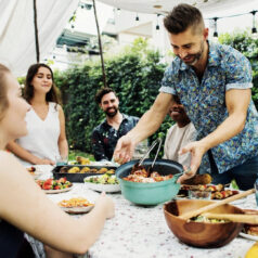 People at outdoor party serving food